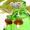 A nice combo of amber and bright green sea glass pieces in a stylish sterling earring.