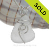 A small perfect piece of whitish sea glass is set in our popular Sea Swirl setting in sterling silver.