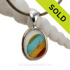 This amazing Super Ultra Rare multi color sea glass piece in a mixed metal Deluxe Wire Bezel© pendant setting.
A versatile Sea Glass Pendant in and a once in a lifetime find!