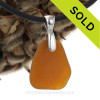 Warm brown sea glass necklace on neoprene cord.