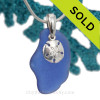 A perfect piece of large blue sea glass on a solid sterling bail and with a silver sand dollar charm.