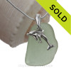Seafoam green sea glass set on a solid sterling cast bail with a sterling silver Mother and Baby Dolphins charm.