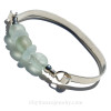 A collection of  beach found glass beads set with sterling details on a thick Solid Sterling flat bangle bracelet.