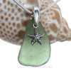 A perfect piece of green sea glass is combined with a solid sterling starfish and presented on an 18 Inch solid sterling snake necklace chain.