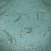 a macro detail of the sea glass in the one earring
