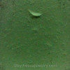 An extreme close-up revealing the telltale crescent shapes formed by decades of wave action, confirming this piece is real sea glass.