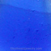 An extreme close-up revealing the telltale crescent shapes formed by decades of wave action, confirming this piece is real sea glass.