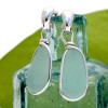 Pale aqua sea glass pieces set in our Original Wire Bezel© setting in sterling silver.
A great pair of natural sea glass earrings on solid sterling silver posts.
This is the EXACT pair you will receive!