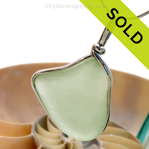  beautiful piece of seafoam green sea glass set in our Original Wire Bezel pendant setting. This leaves the sea glass piece totally unaltered from the way it was found on the beach!
Sorry this Sea Glass Jewelry selection has been SOLD!