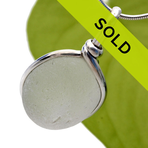 Pure white sea glass pendant in our sterling silver Original Wire Bezel© setting. This setting securely encases the sea glass without altering or damaging it!