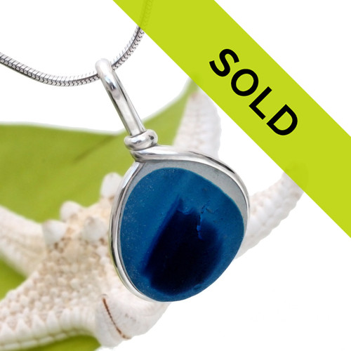 Flashed mixed blue sea glass from the UK set in our Original Wire Bezel© necklace setting.