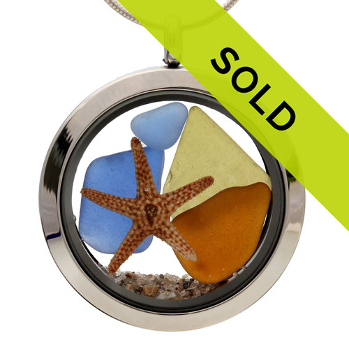 Sea glass in jeweltone colors of green, amber and blues combined with a real starfish and beach sand in this one of a kind stainless steel locket necklace.
The olive green piece is very cool with embossing on it.

SORRY THIS PIECE HAS SOLD!