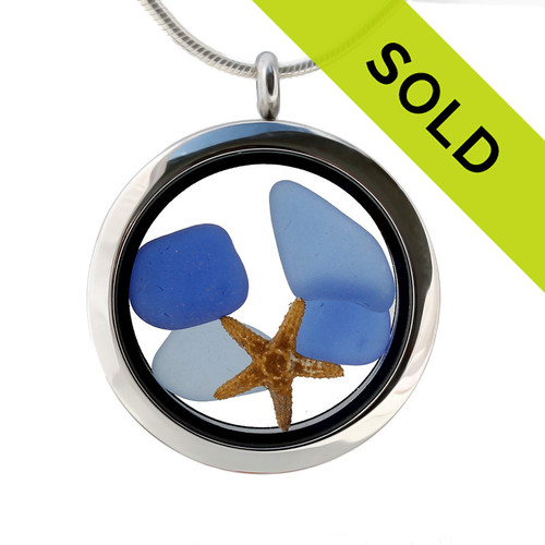 Light and dark Blue sea glass pieces combined with a a pair of real starfish in this sea glass locket necklace.