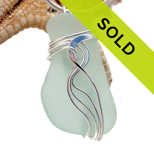 A perfect natural sea green sea glass piece set in our signature Waves setting.