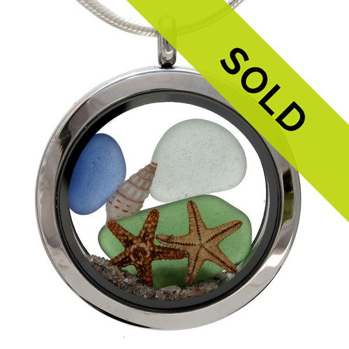 Blue, green and amber genuine beach found sea glass pieces combined in an beachy scene with two starfish  in a stainless steel locket necklace.

Real beach sand completes this beachy look.

This locket is totally customizable by you. 