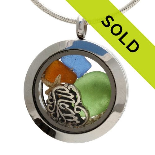 Real jewel tone sea glass pieces combined with a small real starfish and beach sand in this snmaller sea glass locket necklace.
A sterling silver heart shaped MOM charm lets her know you are always on her mind, at the beach and always!