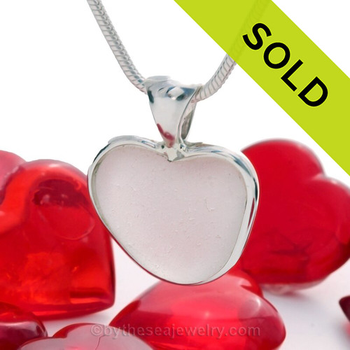 A beautiful pure white natural sea glass heart set in our deluxe wire bezel setting!