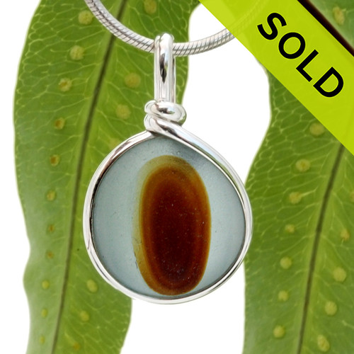 A beautiful larger piece of vivid blue green sea glass with a vivid amber center set for a necklace in our Original Sea Glass Bezel© in solid sterling silver setting.
SOLD - Sorry this Rare Sea Glass Pendant is NO LONGER AVAILABLE!