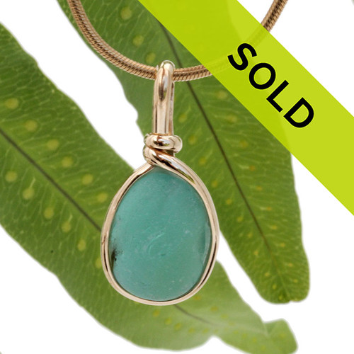 A nice piece of deep seafoam or aqua green with in our signature Original Wire Bezel© in gold pendant setting that leaves both front and back open and the glass unaltered from the way it was found on the beach.
Sorry this sea glass jewelry piece has been sold!
