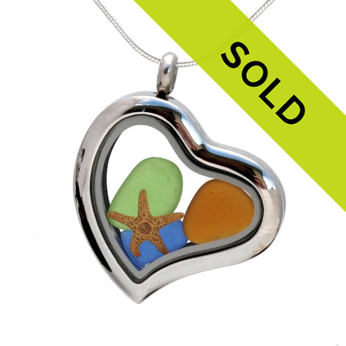 Our new heart lockets make this blue, lime green and amber sea glass really shine! A tiny starfish completes the beachy look!
Genuine beach found glass.