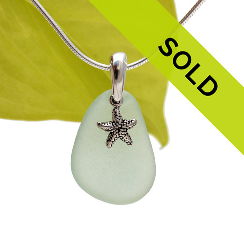A bright seafoam green piece of TOP QUALITY sea glass set on a solid sterling bail with a sterling starfish charm.
Sorry this pendant has sold!