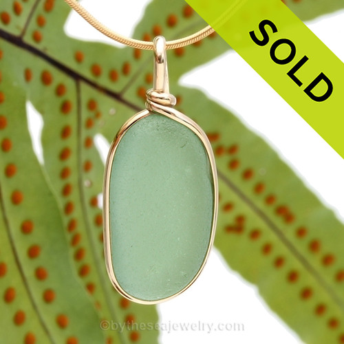 A nice piece of bright glowing seafoam or aqua green with in our signature Original Wire Bezel© pendant setting that leaves both front and back open and the glass unaltered from the way it was found on the beach.