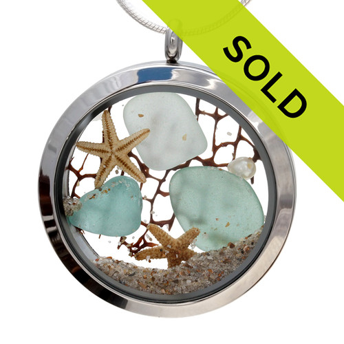 Genuine aqua and sea green sea glass piece combined with a real pearls, sea fan, starfish and a real beach sand in this JUMBO 35MM stainless steel locket.