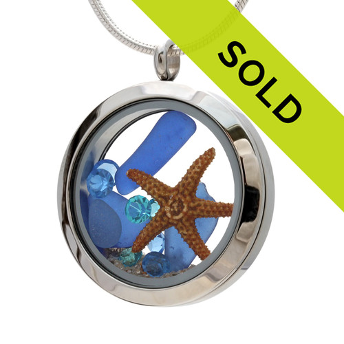 Real beach found blue sea glass and a real starfish in this Stainless steel locket.
Blue Topaz and zircon birthstones makes this a great gift for any December Birthday