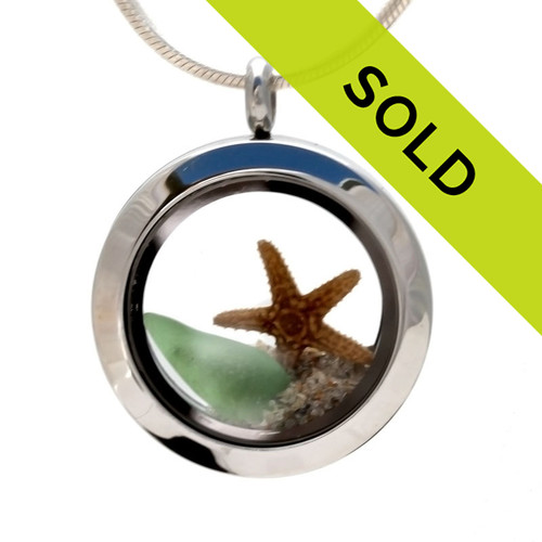 One of the last of our smaller sea glass lockets with green sea glass and a real starfish and beach sand.