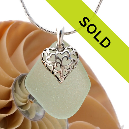 A large piece of natural seafoam green sea glass set on a solid sterling hand cast bail with a sterling silver heart in hearts puff charm. A perfect sea glass necklace for any sea glass lover!
Sorry this sea glass necklace has been sold!