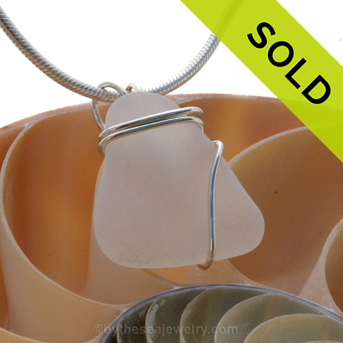 A small inexpensive white sea glass pendant set in silver.
Sorry this sea glass jewelry piece has been sold!