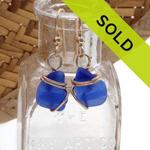 A beautiful pair of natural vivid  blue beach found sea glass pieces set in a simple wire wrapped goldfilled setting