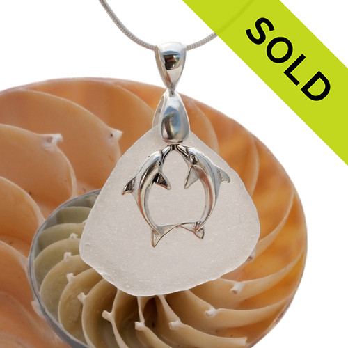 A stunning piece of white GENUINE sea glass pendant with a LARGE SOLID STERLING kissing dolphins charm.
Sorry this Sea Glass Jewelry selection has been SOLD!