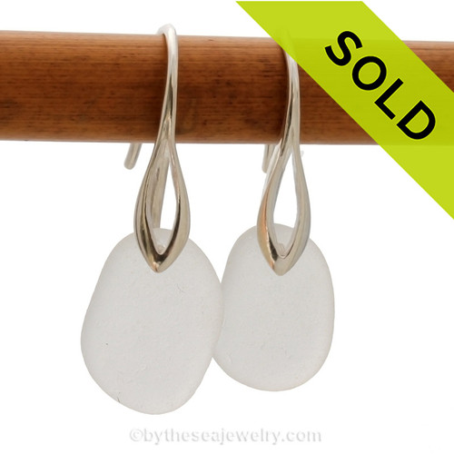 A pair of natural beach found sea glass earrings in a winter white on sterling silver deco hooks.
Sorry this sea glass jewelry selection has been sold!