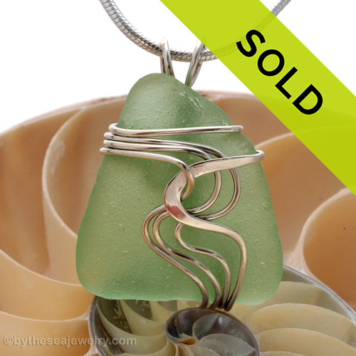 Top quality seafoam green sea glass set in our signature WAVES pendant setting. This setting leaves the sea glass totally UNALTERED from the way it was found on the beach!
Sorry this sea glass jewelry piece has been sold!