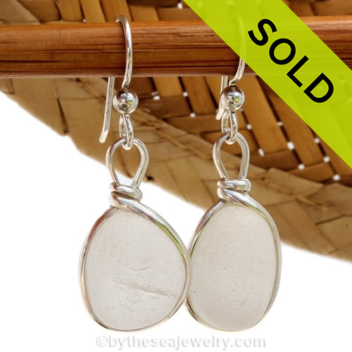 A lovely pair of pure white English sea glass earrings in our Original Bezel Wire© setting in solid sterling silver.
 This amazing thick and frosty genuine sea glass from Seaham England captures and holds the light to make this beach found sea glass gems shine. One does have a small crizzle line but only adds to the authenticity of the glass.