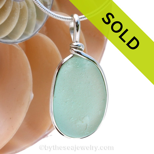 A lovely piece of beach found glass from Seaham England in a stunning aqua green is set in our Original Wire Bezel© pendant setting.
Sorry this piece of sea glass jewelry has been sold!