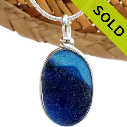 This ultra rare Seaham blue sea glass multi color pendant is set in our Original  Wire Bezel© pendant setting. The accidental mixture of colors almost resembles a sea scene.