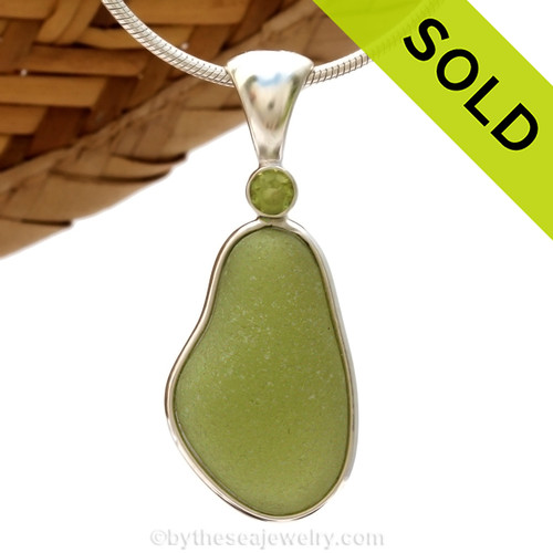 This beautiful Bright Peridot Green sea glass piece is set in our Deluxe Wire Bezel© pendant setting with a genuine Peridot gem.
SOLD - Sorry this Rare Sea Glass Pendant is NO LONGER AVAILABLE!