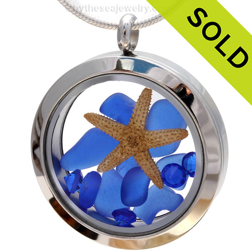 A beautiful pieces of natural blue sea glass combined in a stainless steel locket necklace with a real starfish & Sapphire crystal Gems.
Sorry this Sea Glass Jewelry piece has been sold!