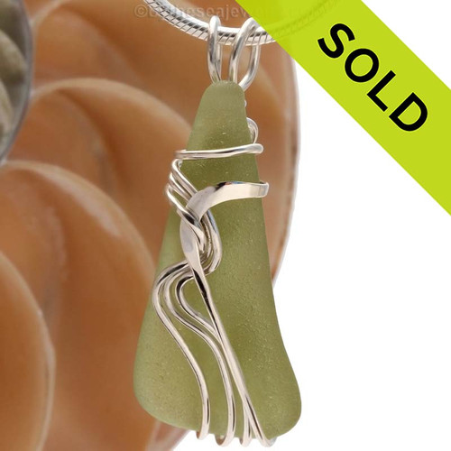 A beautiful natural peridot or pale olive green sea glass pendant set in our original signature "Waves" setting in solid sterling silver.
Sorry, this Sea Glass Jewelry selection has been SOLD!