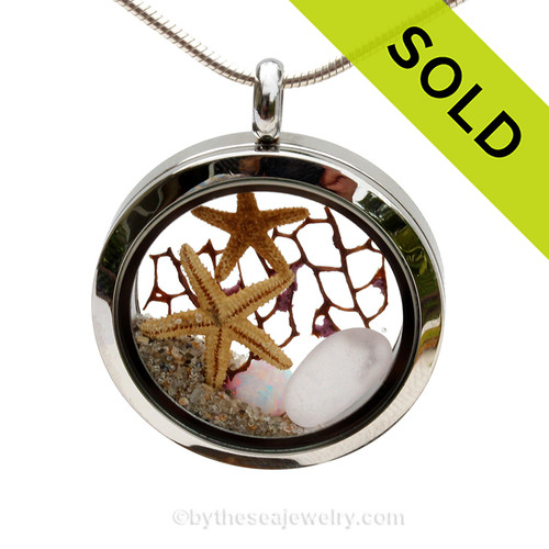 Pale lavender sea glass combined with two baby starfish, sea fan, as simulated opal and beach sand in this twist top stainless steel locket necklace.
SOLD - Sorry this Sea Glass Locket is NO LONGER AVAILABLE!