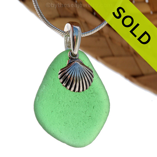 Larger Green sea glass set on a solid sterling cast bail with a sterling silver shell charm.
Sorry this Sea Glass Necklace has been SOLD!