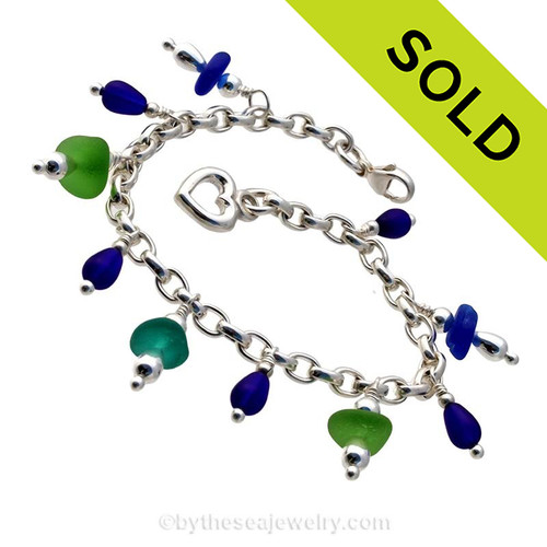 5 pieces of genuine beach found sea glass combined frosted cobalt blue beads in a totally solid sterling silver bracelet and finished with a solid sterling heart charm.
