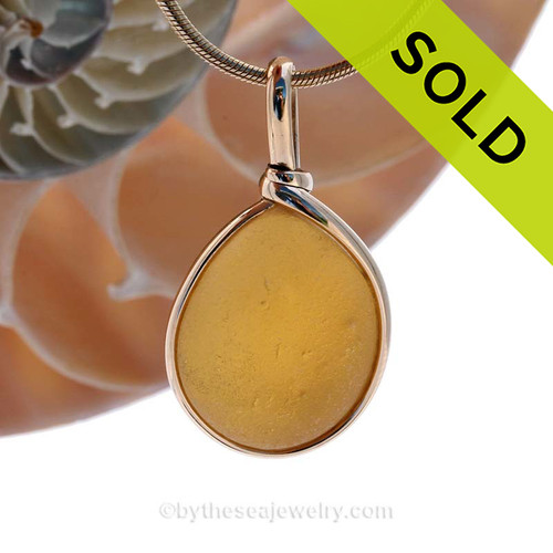 This beautiful Bright Vivid Golden Yellow sea glass pendant is set in our Original Wire Bezel© pendant setting in a 14K Rolled Gold.
SOLD - Sorry this Ultra Rare Sea Glass Pendant is NO LONGER AVAILABLE!