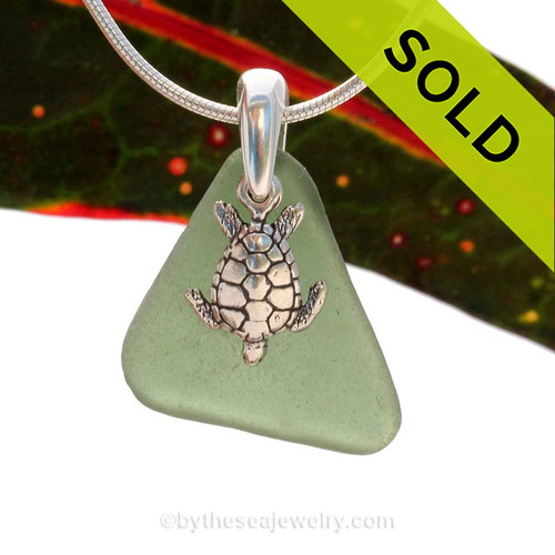 A rarer Seaweed or Jungle Green sea glass necklace set on a solid sterling cast bail with a sterling silver Turtle charm.
Sorry this Sea Glass Jewelry selection has been SOLD!