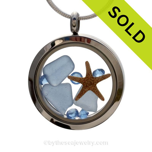 A beautiful pieces of natural Carolina blue sea glass combined in a stainless steel locket necklace with a real starfish and light blue crystal gems. 
SOLD - Sorry this Sea Glass Jewelry selection is no longer available.