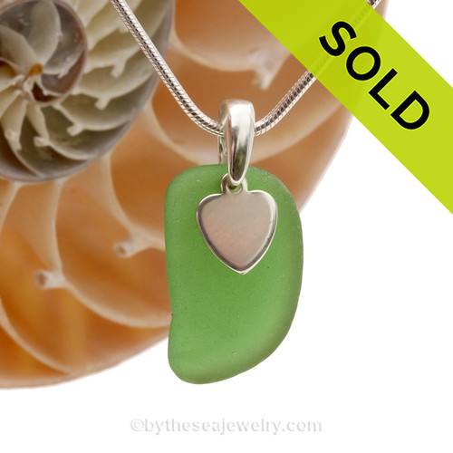 A nice piece of bright green genuine sea glass with a solid sterling bail and simple heart charm.
SOLD - Sorry this Sea Glass Necklace is NO LONGER AVAILABLE!
