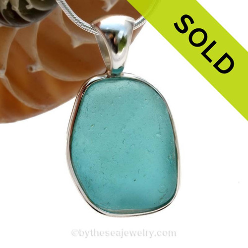 A LARGE and curvy piece of Vivid Electric Aqua Blue Genuine Sea Glass in our In Our Deluxe Sterling Wire Bezel© Necklace Pendant.
SOLD - Sorry this Rare Sea Glass Pendant is NO LONGER AVAILABLE!