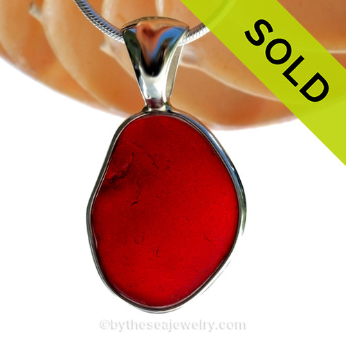 This is a very LARGE Genuine Ruby Red Sea Glass Pendant in our deluxe Wire Bezel setting.